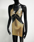 Gold metallic chain bra top and mini skirt set on mannequin, ring front detail