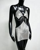 Silver metallic chain bra top and mini skirt set on mannequin with ring centerpiece
