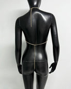Gold metallic chain halter bra top back on mannequin with long center chain