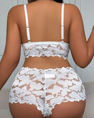 Back view of white floral lace bra with adjustable straps and matching lace shorts