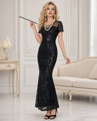 Black sequin maxi dress with high slit, short sleeves, fitted column silhouette