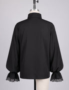 Back view of black button-up shirt with lace-trim sleeve cuffs