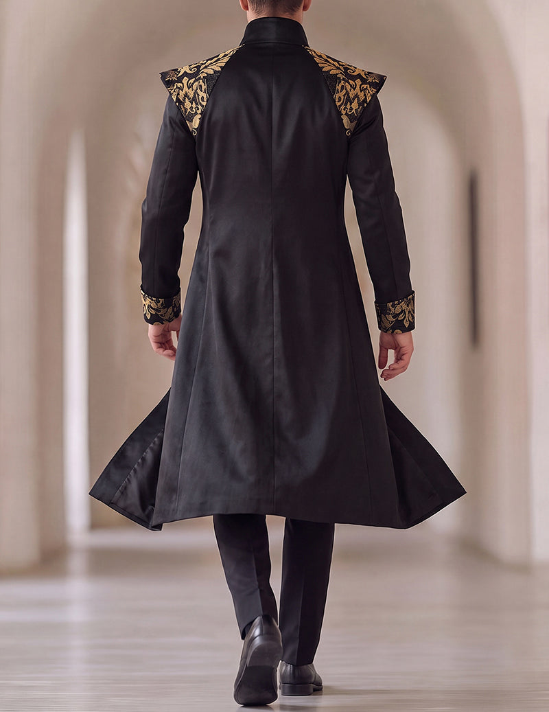 Black long frock coat from back with gold baroque sleeve cuffs and flared hem