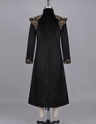 Black long frock coat on mannequin with stand collar and ornate gold cuff trim