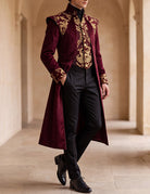 Dark red long frock coat with gold baroque trim, stand collar, and flared back hem