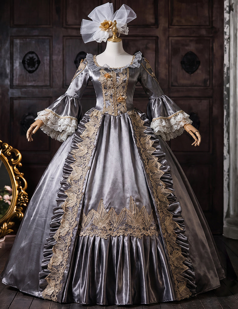 Charcoal gray medieval court gown on mannequin with gold embroidery and lace-trim bell sleeves
