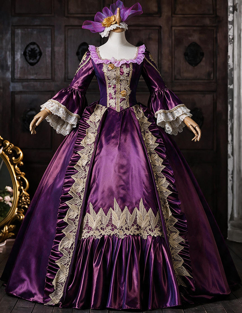 Royal purple medieval court gown on mannequin with ornate gold embroidery and lace cuffs