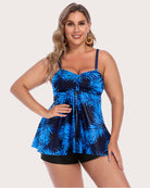 Two-piece tankini set with blue tropical-leaf tankini top and black swim shorts