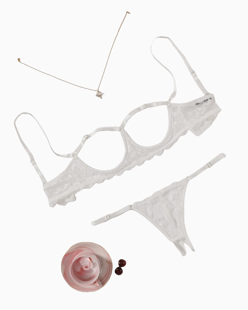White lace bra and thong panty set, flat lay with thin straps and scalloped edges