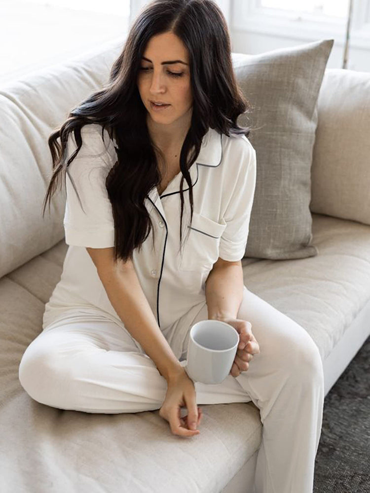 White pajama set with short-sleeve button shirt and long pants, contrast trim