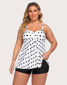 Two-piece tankini set with white tankini covered in black dots and black swim shorts