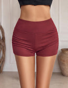 Wine red high-rise ruched mini shorts with elastic waistband