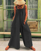 Black sleeveless backless bodysuit with wide-leg trousers, gathered neckline