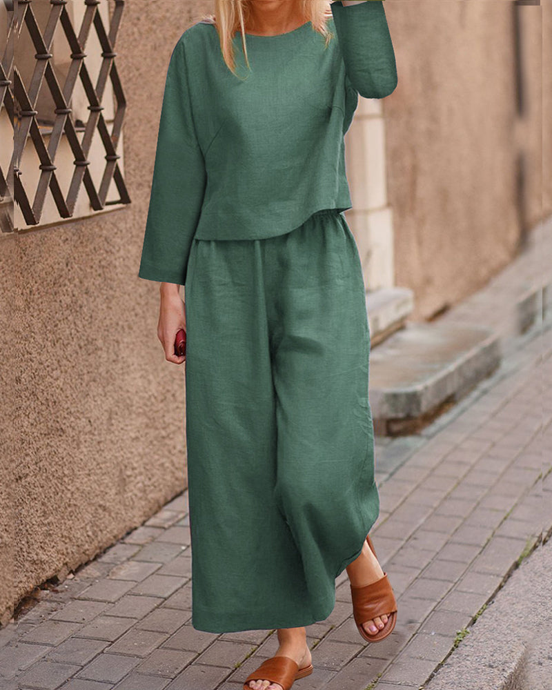 Dark green long-sleeve two-piece set: layered top and wide-leg pants