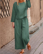 Dark green long-sleeve two-piece set: layered top and wide-leg pants