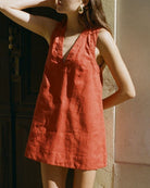 Red sleeveless loose mini dress with V-neck, gathered front