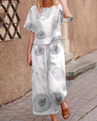 White two-piece set with short-sleeve top and matching wide-leg pants, gray circles