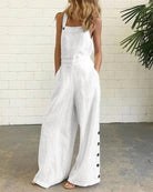 White wide-leg bib romper with adjustable straps and side button placket
