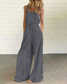 Dark grey wide-leg bib romper with side button placket and roomy straight legs